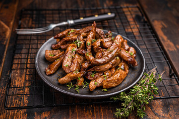 Traditional Asian beef teriyaki with herbs on a plate. wooden background. top view