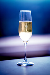 A glittering glass of Champagne with beautiful Blue back and gray background