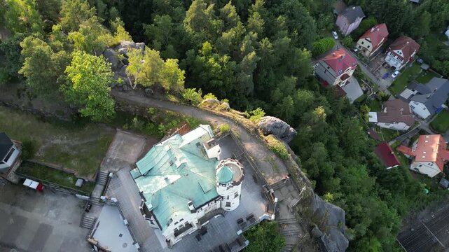 Aerial drone footage of the Pastyrska Stena lookout tower in Decin, Czech Republic. Scenic panoramic views of the historic tower, sandstone cliffs, and the Elbe River surrounded by nature 