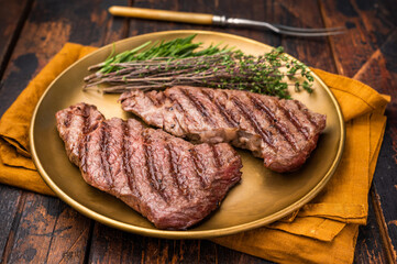 Juicy Denver, chuck eye steak, expertly grilled to perfection, offering a mouthwatering aroma and a deliciously charred exterior. wooden background. top view