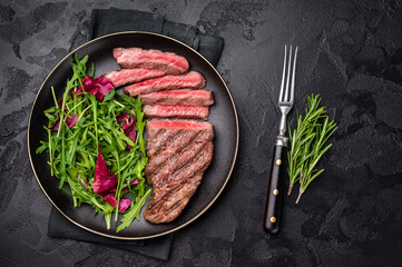Succulent Denver cut, showcasing a perfect sear and rich color after grilling. black background. top view
