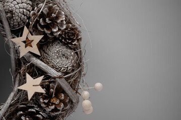 Christmas wreath with cones and wooden stars.