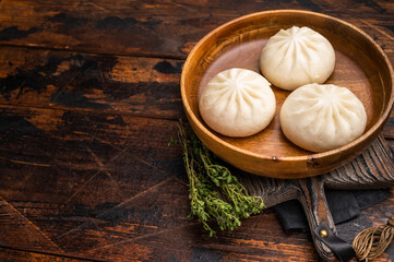 Dumpling Momos with pork meat in wooden plate. wooden background. top view
