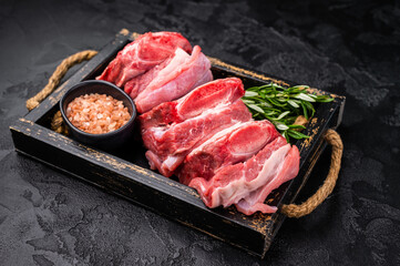 Raw Veal Short Rib, fresh beef meat with bone and herbs for cooking . black background. top view