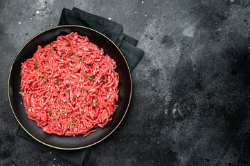 Lamb Mutton ground mince raw meat, forcemeat on a black plate, top view.