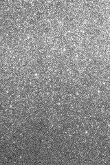 Silver glitter texture with sparkling metallic highlights and shiny reflective elements