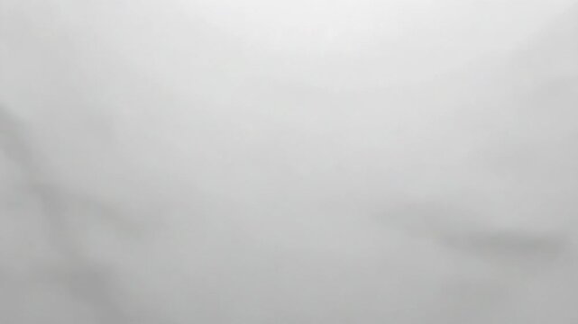 A close-up view of a sheet of white paper with a subtle texture and natural creases