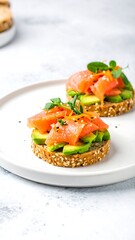 Two healthy toast with salmon, avocado, and herbs