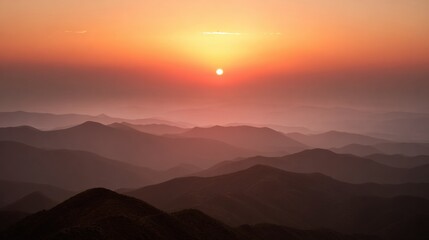 Obraz premium Vivid Sunset Over Mountain Ranges With Soft Hues and Distant Silhouettes Creating a Tranquil Atmosphere in the Evening Sky