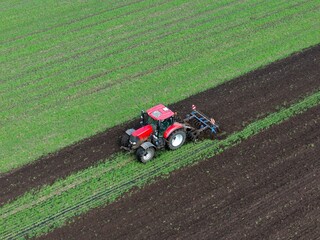 tractor and plow on a field, aerial view, farmland, landscape, agriculture	