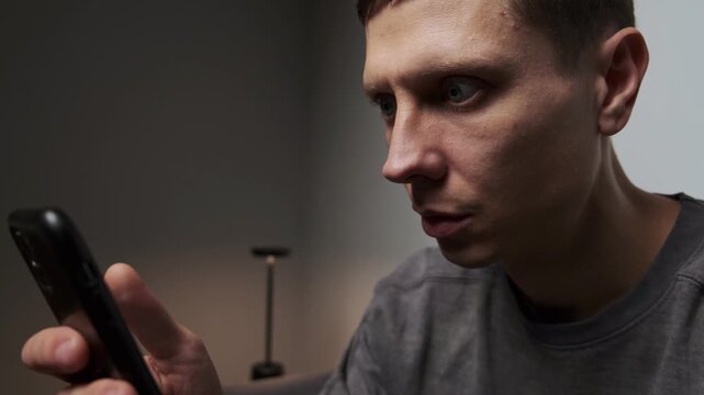 Addiction to Social Media Scrolling Close Up Man with Blank Face Expression Illustrating Mindless Content Consumption.