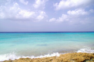 wave rolling onto sandy beach in caribbean