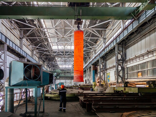 Hardening of pipe in special furnace, hot iron pipe on crane