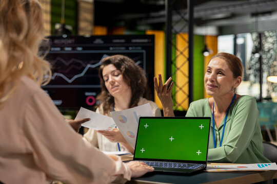 Team of goals oriented managers work with a chroma key screen on device in a modern boardroom, hosting a business discussion with monthly reports insight. Company strategy for growth.