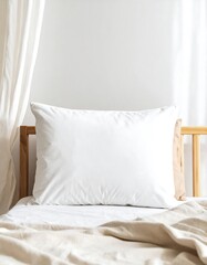 White pillow on a bed in a light room