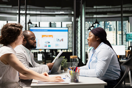 HR department team discussing with black woman about career opportunity, selecting candidates during job interview session in a corporate office. Applicant focused on strong career ambition.