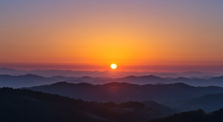 Obraz premium Majestic Sunset Over a Layered Mountain Landscape with a Golden Sky.