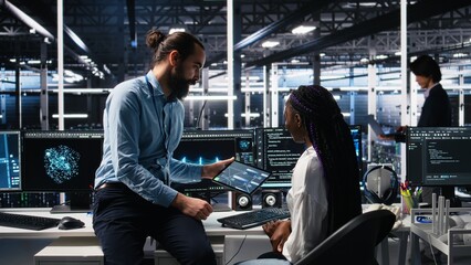 System administrator and employee in data center coding with generative AI. Team leader and IT...