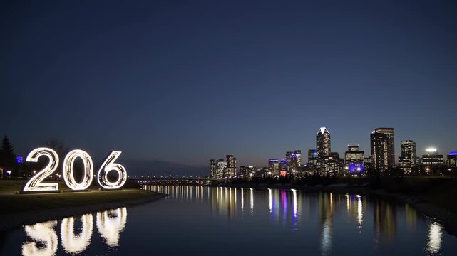 Illuminated Number 206 Displayed by a Riverbank with Calgary Skyline in the Background, Captured During Twilight for a New Year Celebration