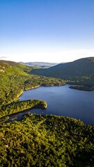 Naklejka premium High-angle view of a lake nestled in a mountain valley