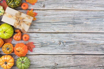 Top view fall composition with cardboard gift box pumpkins and leaves