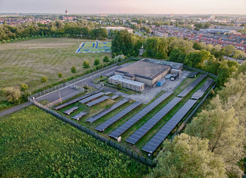 Aerial view of small local data center in the Netherlands with a lot of solar panels, online cloud storage locally