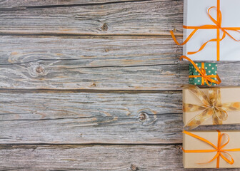 Four decorative gift packages on wood top view with empty space
