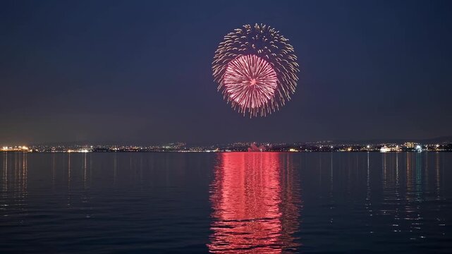 Fireworks Illuminate the Night Sky Over Thessaloniki, Reflecting Brilliantly on the Calm Sea Below, Capturing a Festive Atmosphere