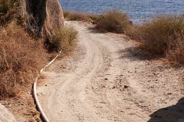 Scenic Coastal Path Leading to a Tranquil Blue Bay
