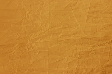 Abstract wrinkled golden crumpled paper texture background