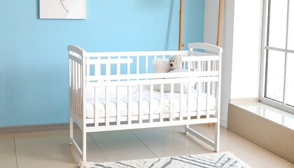 A pristine white crib sits serenely in a light blue nursery, bathed in natural light.