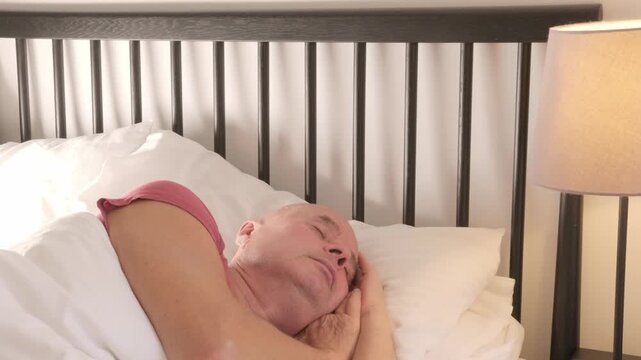 mature senior man sleeping peacefully in bed, healthy nighttime rest and importance quality sleep, need for rest, balance, and relief from insomnia-related issues, prevention disorders