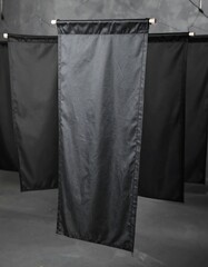 Four black banners hang on a gray background