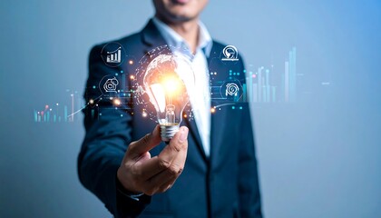 A business professional holds a glowing lightbulb, signifying innovative ideas and data-driven solutions.