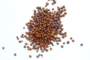 Brown dried allspice spice seeds.