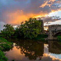 Fototapeta premium Dramatic sunset over a river and castle