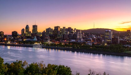 A vibrant cityscape panorama of Montreal at sunset, showcasing illuminated skyscrapers, a river, and lush greenery on the horizon.