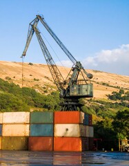 Industrial crane overlooking shipping containers