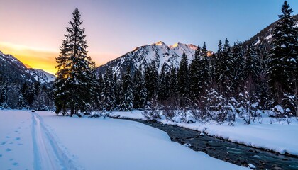 Fototapeta premium A tranquil winter landscape at dawn, showcasing a snow-covered river winding through a dense forest, with majestic mountains in the background, bathed in the soft light of sunrise.