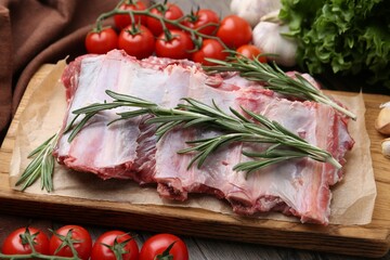 Fresh raw beef ribs and ingredients on table, closeup