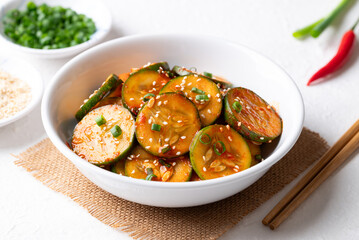 Korean cucumber salad (Oi muchim) in bowl on white background, Korean side dish
