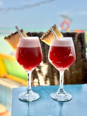 red cocktail on the beach