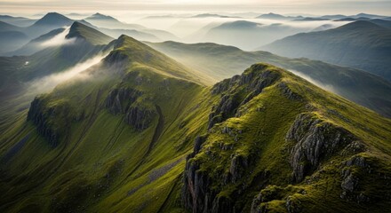 Green Mountain Range with Misty Clouds and Rocky Peaks in Scenic Landscape