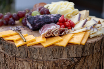 Buffet table is ready with charcuterie board items with plenty of cheese for the wedding reception guests