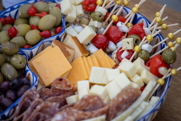 Overhead view of the buffet table is ready with charcuterie board items such as cheese and fruit for the wedding reception guests