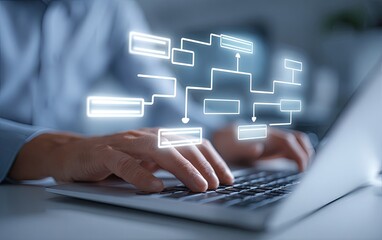 Close-up of hands typing on a laptop, a flowchart projected onto the screen