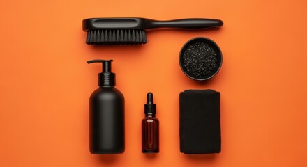 A collection of black mens grooming products including a brush, oil, and styling product, arranged on an orange background
