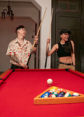 young couple playing pool