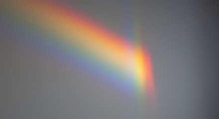 Prism splitting sunlight on white wall, rainbow spectrum vibrating at the edges.