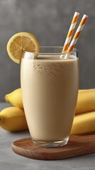 Creamy banana milkshake in glass, ripe bananas beside Perfect summer treat - summer delicious dessert countertop